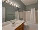 Bathroom featuring large mirror with vanity lighting, white shower, tub, and toilet at 1453 Cambridge Cmn, Decatur, GA 30033