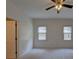 Bright bedroom features neutral carpet, two windows with blinds, and a ceiling fan at 1453 Cambridge Cmn, Decatur, GA 30033