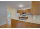 Functional kitchen layout with wood cabinetry, white appliances, and hardwood flooring at 1453 Cambridge Cmn, Decatur, GA 30033