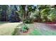Lush backyard, offering a serene and private outdoor space surrounded by mature trees at 203 Cedar Creek Ct, Acworth, GA 30101