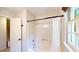 Clean bathroom featuring a shower/tub combination with white shower curtain and wood accents at 203 Cedar Creek Ct, Acworth, GA 30101