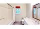 Bright bathroom featuring a tub/shower combo, marble topped vanity and dark tile floors at 203 Cedar Creek Ct, Acworth, GA 30101