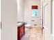 Powder room featuring a dark wooden vanity, and earth tone tile flooring at 203 Cedar Creek Ct, Acworth, GA 30101