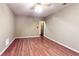 A bright bedroom offers hardwood floors and a ceiling fan with lights at 203 Cedar Creek Ct, Acworth, GA 30101