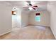 Spacious bedroom with neutral carpeting, ceiling fan, and large window at 203 Cedar Creek Ct, Acworth, GA 30101