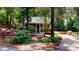 Charming house with a covered porch and well-maintained landscaping and wooded surroundings at 203 Cedar Creek Ct, Acworth, GA 30101