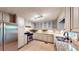 Well-lit kitchen featuring stainless steel appliances, tile floor, and generous counter space at 203 Cedar Creek Ct, Acworth, GA 30101