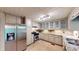 Well-lit kitchen featuring stainless steel appliances, tile floor, and generous counter space at 203 Cedar Creek Ct, Acworth, GA 30101