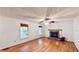 Bright living room features a stone fireplace, hardwood floors, and plentiful natural light at 203 Cedar Creek Ct, Acworth, GA 30101