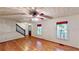 Bright living room features hardwood floors, staircase, and windows with custom shades at 203 Cedar Creek Ct, Acworth, GA 30101