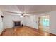 Inviting living room with hardwood floors, stone fireplace, and access to sunroom at 203 Cedar Creek Ct, Acworth, GA 30101