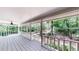 Relax on this covered porch with white railing and a view of the lush surroundings at 203 Cedar Creek Ct, Acworth, GA 30101
