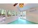 Bright sunroom features shiplap walls, a unique light fixture, and many windows offering scenic outdoor views at 203 Cedar Creek Ct, Acworth, GA 30101