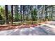 Fenced yard with mature trees, providing privacy and a connection to nature at 203 Cedar Creek Ct, Acworth, GA 30101