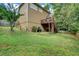 Landscaped backyard featuring a well-maintained lawn and wooden deck at 615 Willowbrook Run, Johns Creek, GA 30022