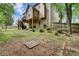 A large backyard with a two-story house, wooden fence, a deck and a large yard at 615 Willowbrook Run, Johns Creek, GA 30022