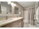 Bathroom featuring double vanity, framed mirrors, and neutral color palette at 615 Willowbrook Run, Johns Creek, GA 30022