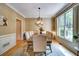 Dining room featuring hardwood floors, textured wallpaper, and many seats at 615 Willowbrook Run, Johns Creek, GA 30022
