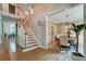 Foyer featuring wooden staircase and dining room at 615 Willowbrook Run, Johns Creek, GA 30022
