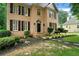 Beautiful brick home with a well-maintained lawn and classic architectural details at 615 Willowbrook Run, Johns Creek, GA 30022