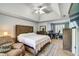Spacious primary bedroom featuring a tray ceiling, seating area, and large windows at 615 Willowbrook Run, Johns Creek, GA 30022