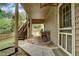 Covered outdoor patio with dining table, chairs, and stairway at 615 Willowbrook Run, Johns Creek, GA 30022