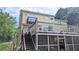 View of the home's two-story wooden deck with screened-in porch and stairs to the backyard at 75 Maygold St, Mcdonough, GA 30253