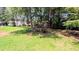 Picturesque backyard featuring a well-maintained lawn and a charming wooden bridge feature at 75 Maygold St, Mcdonough, GA 30253