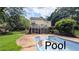 Backyard featuring a large in-ground swimming pool, patio and lush greenery at 75 Maygold St, Mcdonough, GA 30253