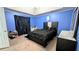 Modern bedroom with blue walls, carpeted floors, and tray ceiling at 75 Maygold St, Mcdonough, GA 30253