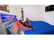 Cozy bedroom with plush pillows, a bed featuring LED lighting and an ensuite bathroom at 75 Maygold St, Mcdonough, GA 30253