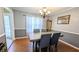 Inviting dining room with hardwood floors, table with four chairs, and elegant chandelier at 75 Maygold St, Mcdonough, GA 30253
