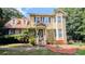 Charming two-story home with yellow siding, blue shutters, and well-maintained front yard at 75 Maygold St, Mcdonough, GA 30253