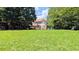 Traditional two-story home with a neatly manicured front lawn and mature shade trees at 75 Maygold St, Mcdonough, GA 30253