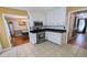 Functional kitchen with white cabinets, stainless steel stove, and adjacent dining area at 75 Maygold St, Mcdonough, GA 30253
