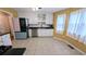 Bright kitchen featuring white cabinets, stainless steel appliances, and tiled flooring at 75 Maygold St, Mcdonough, GA 30253