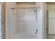 Tiled shower-tub with a shower head and grab bars offers a safe and clean bathroom design at 8455 Abingdon Ln, Duluth, GA 30097
