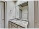 Well-lit bathroom featuring granite countertops, a large mirror, and neutral-toned cabinetry at 8455 Abingdon Ln, Duluth, GA 30097
