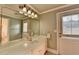 Bright bathroom with a large mirror, white vanity, and neutral decor at 8455 Abingdon Ln, Duluth, GA 30097