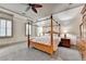 Spacious bedroom with a ceiling fan, two windows with blinds, and a decorative wooden four-poster bed at 8455 Abingdon Ln, Duluth, GA 30097