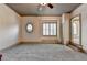 Spacious room with a unique window, built-in cabinets, and plush carpeting at 8455 Abingdon Ln, Duluth, GA 30097