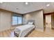 Cozy bedroom with wood-look floors, a window, and a door to the outside at 8455 Abingdon Ln, Duluth, GA 30097