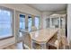 Elegant dining room with a decorative light fixture and natural light from large windows at 8455 Abingdon Ln, Duluth, GA 30097