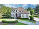 Stately home featuring lush landscaping, a circular driveway, and meticulous lawn at 8455 Abingdon Ln, Duluth, GA 30097