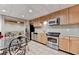 Bright kitchen featuring stainless steel appliances, a tiled floor and view to the living room at 8455 Abingdon Ln, Duluth, GA 30097