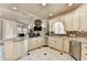 Eat-in kitchen with stainless steel appliances, granite counters, breakfast bar, and an open view of the living room at 8455 Abingdon Ln, Duluth, GA 30097