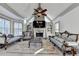 Living room with stone fireplace, vaulted ceilings, large windows, and custom built-in shelving at 8455 Abingdon Ln, Duluth, GA 30097