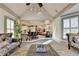 View of the living room and kitchen that shows an open floor plan and lots of natural light at 8455 Abingdon Ln, Duluth, GA 30097