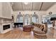 Elegant living room featuring large windows, a fireplace, and a grand piano at 8455 Abingdon Ln, Duluth, GA 30097