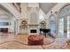 Living room featuring fireplace, large windows and a grand piano at 8455 Abingdon Ln, Duluth, GA 30097